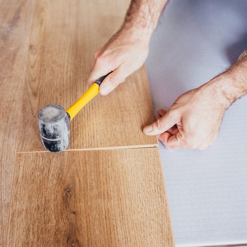 man installing hardwood flooring - Cut-Rite Carpets & Design Center in NY